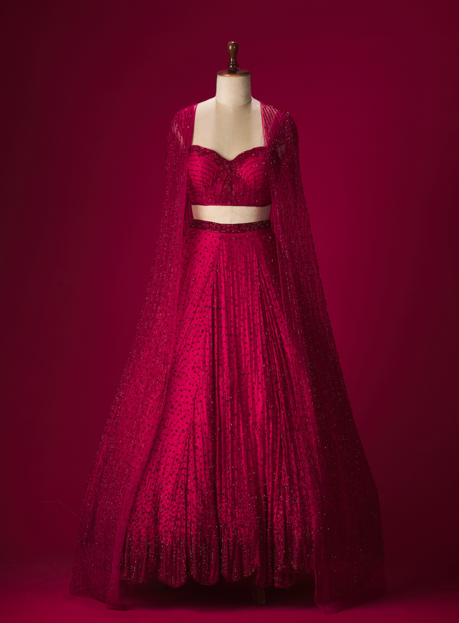 Red crystal-embellished lehenga with structured corset and cutdana cape