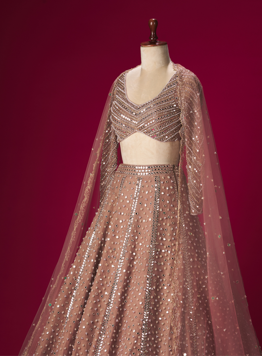 Mauve mirror and pearl work lehenga set with sheer dupatta, side view on a mannequin