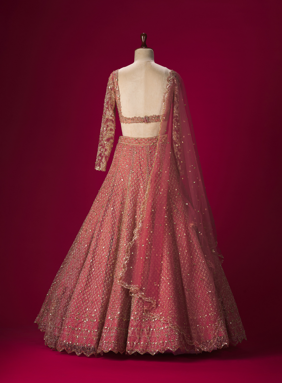 Back view of the peach pita work lehenga with open-back full sleeve blouse and dupatta