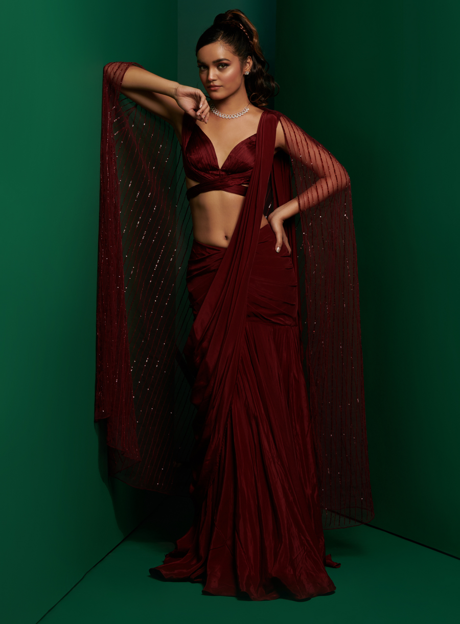 Dark maroon cross body blouse with drape saree and embellished cape