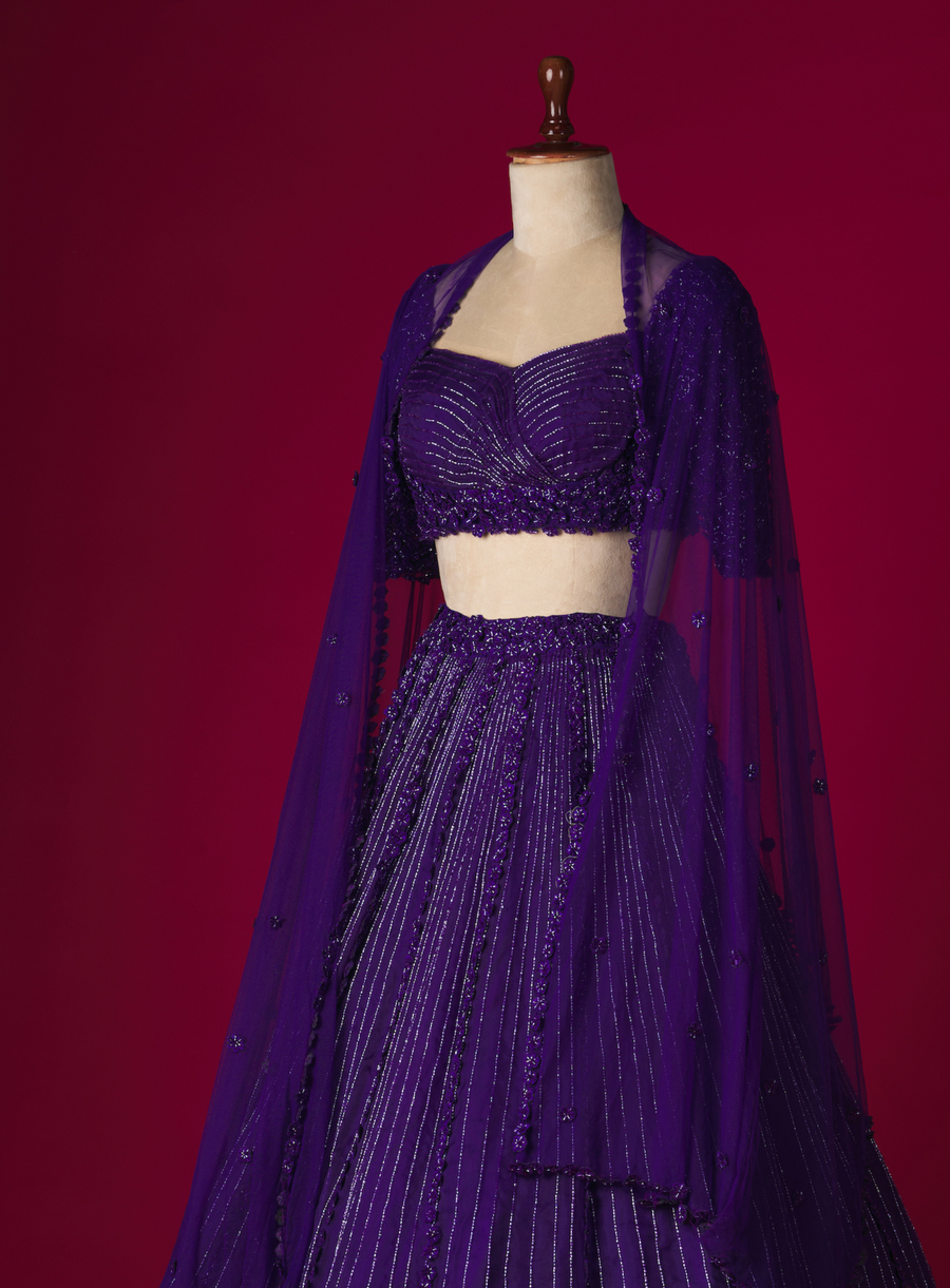 Purple organza lehenga with 3D flower embellished blouse and dupatta, side view on a mannequin