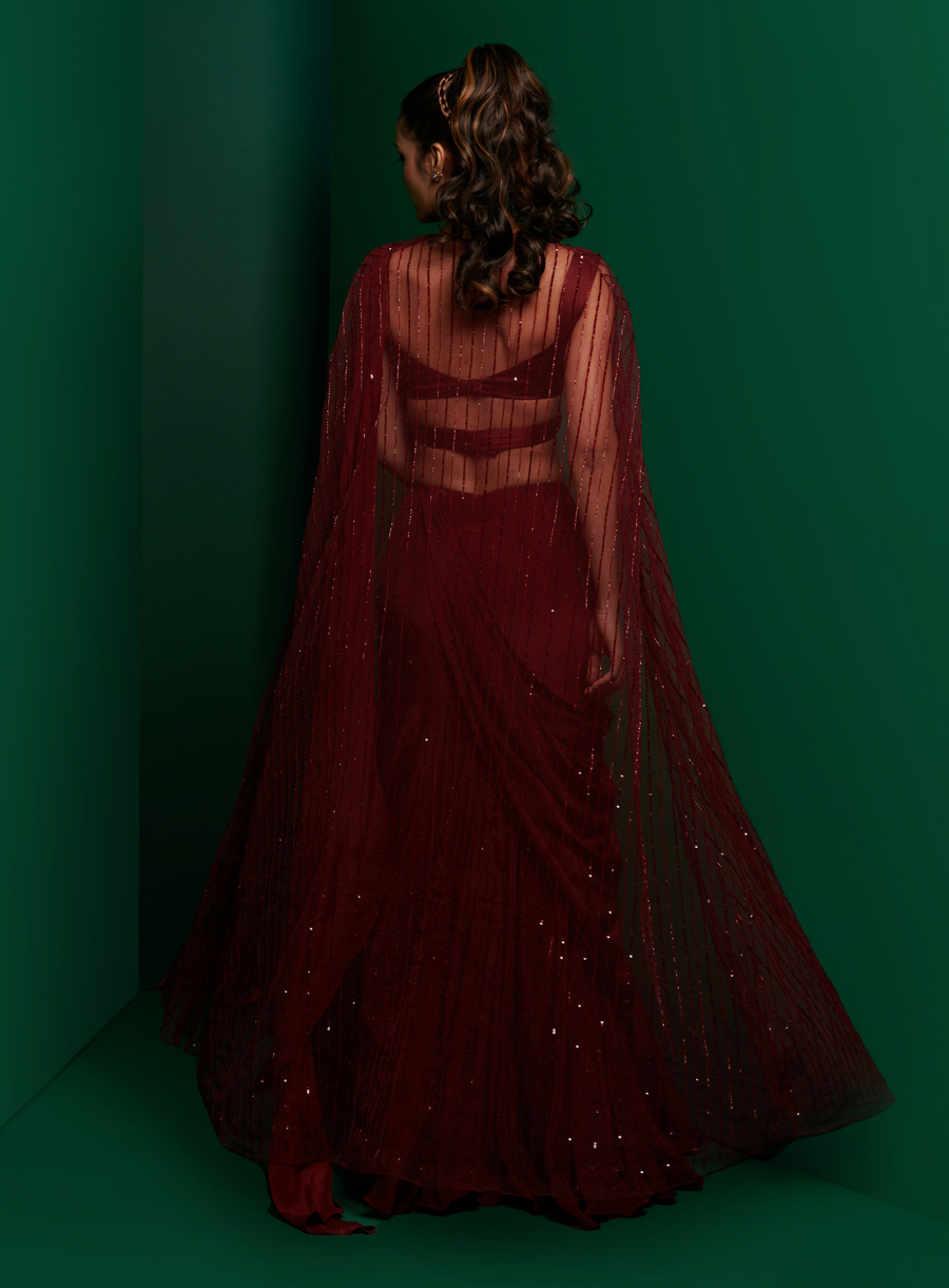 Back view of the dark maroon drape saree with sheer embellished cape