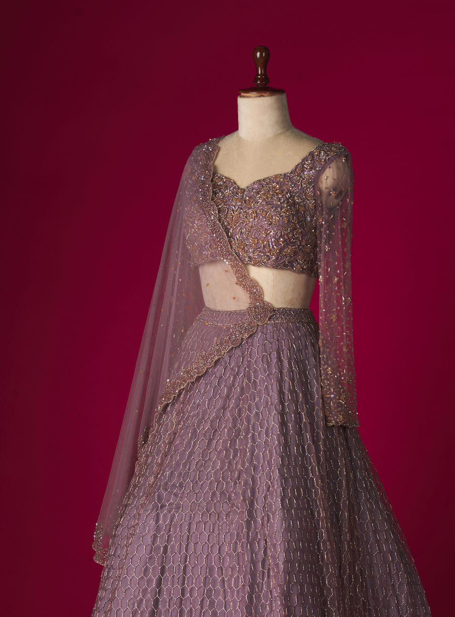 Purple haze lehenga set with embellished blouse and scalloped net dupatta on a mannequin