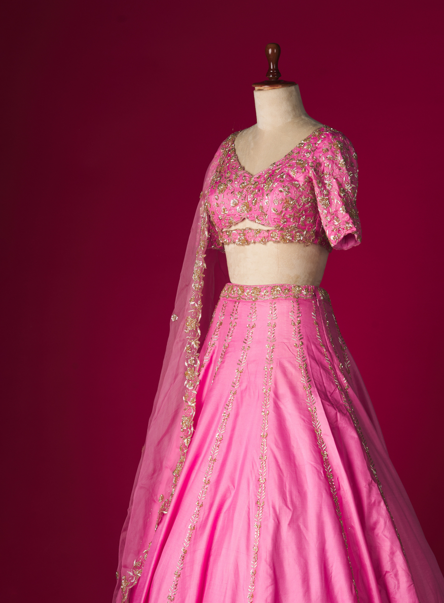 Side view of the pink silk lehenga with zardozi cut-out blouse and dupatta on a mannequin