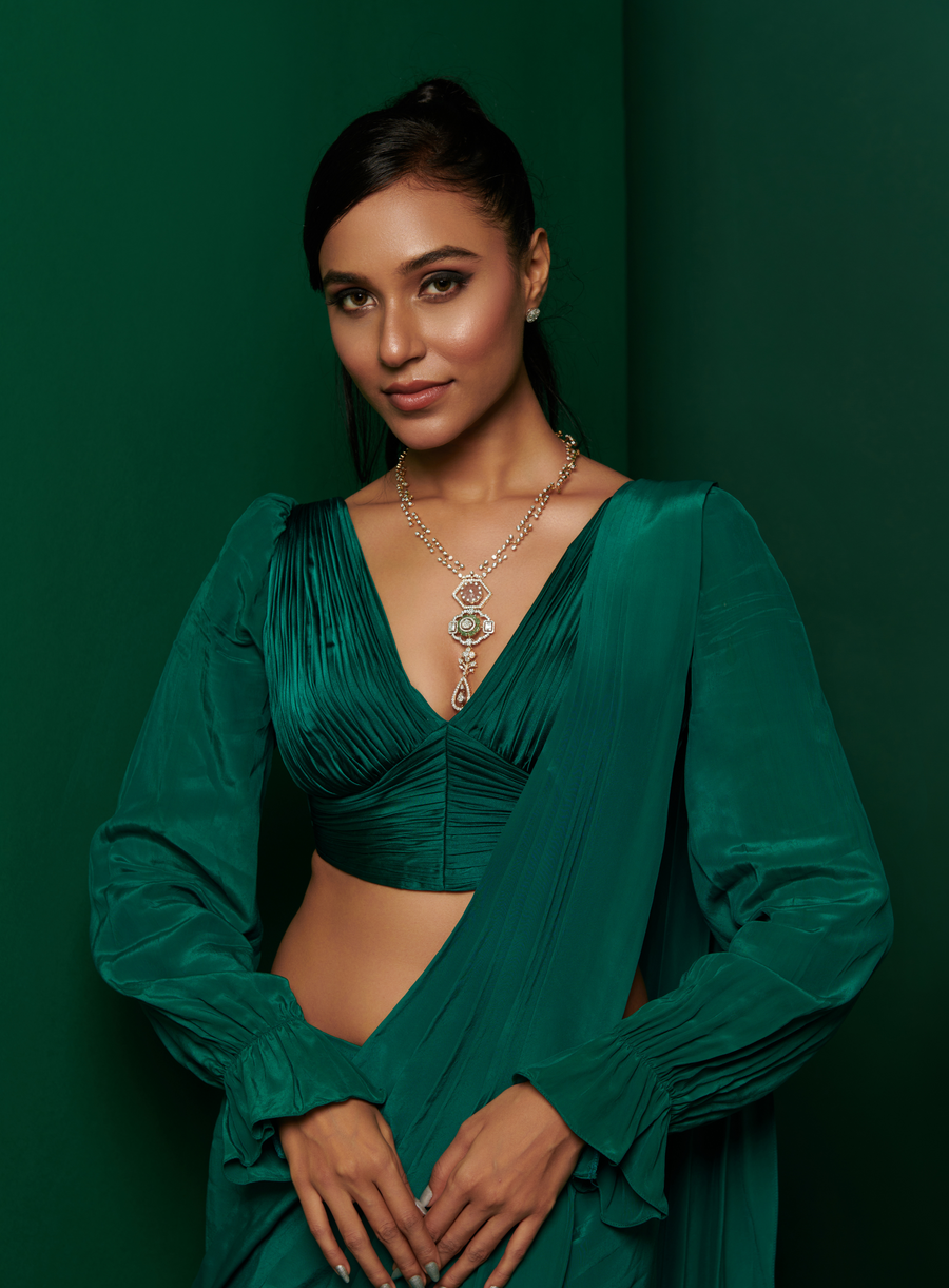 Front view of the bottle green gathered blouse with skirt drape saree