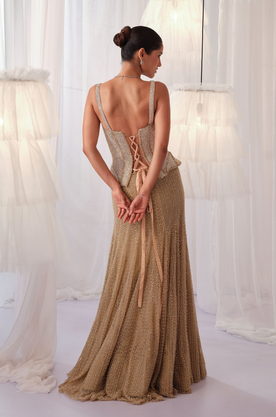 Back view of the champagne gold lace-up corset with fishcut lehenga