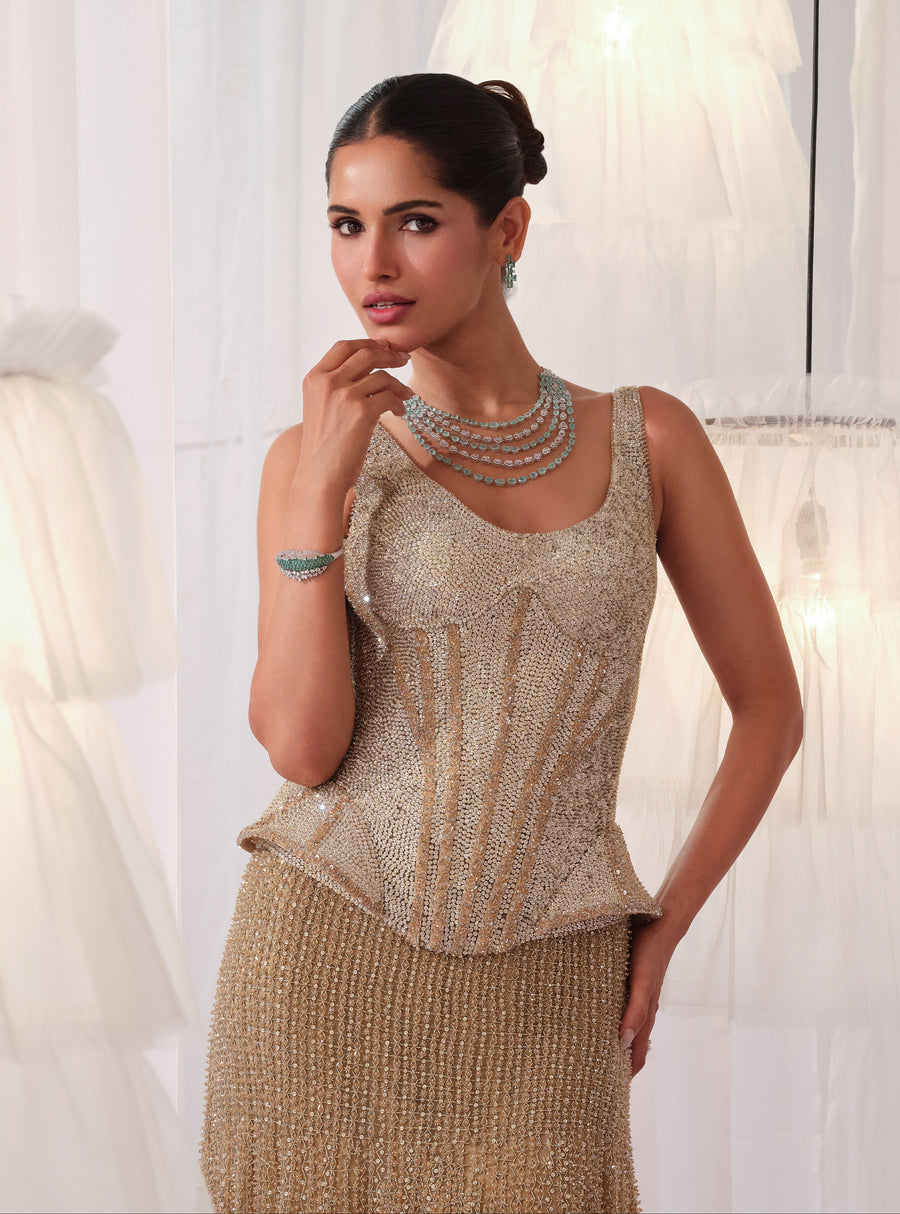 Close-up of the champagne gold scoop-neck peplum corset with crystal embroidery