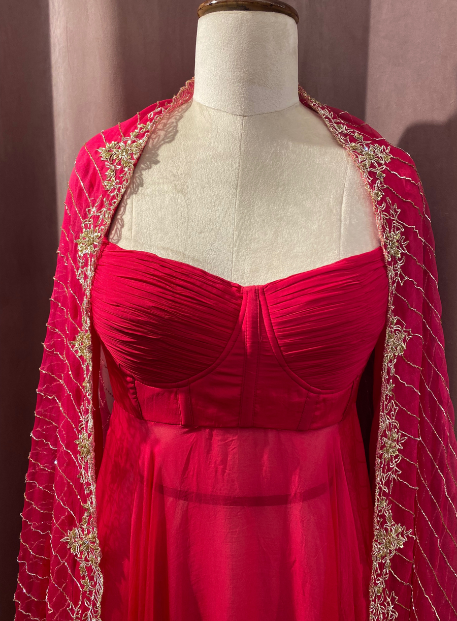 Close-up of the hot pink Anarkali's ruched bodice with zardozi-bordered dupatta