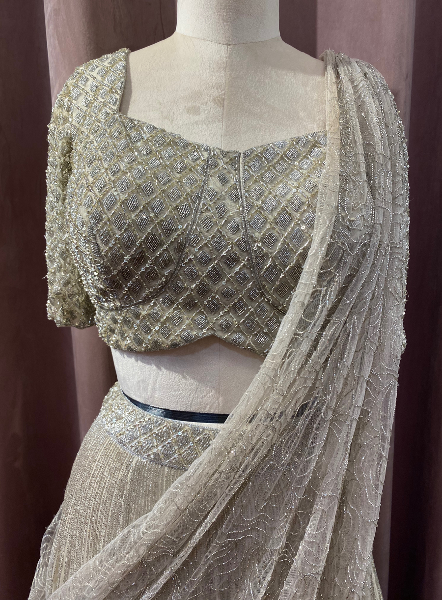 Close-up of the silver glass bead embellished blouse and beaded net dupatta on a mannequin