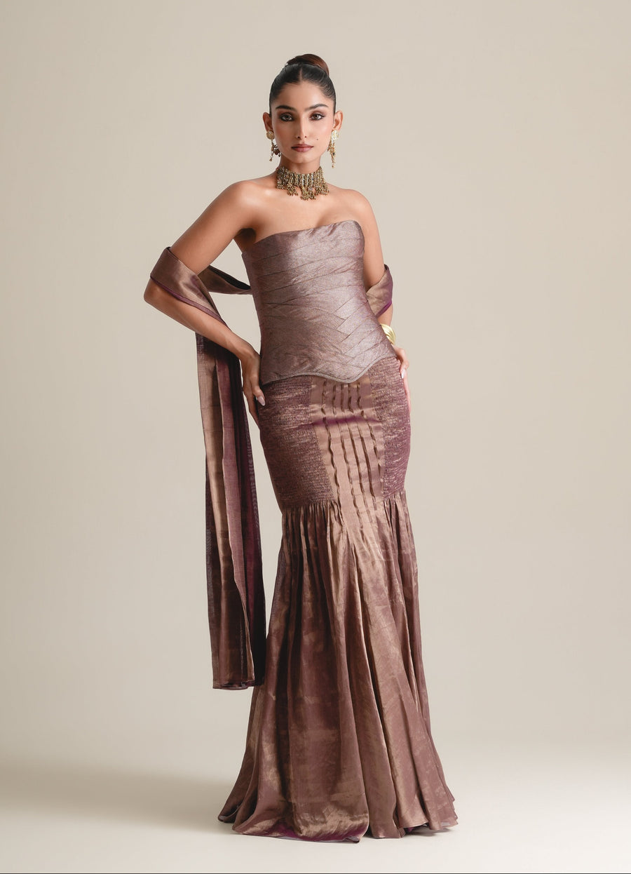 Bronze-mauve metallic strapless corset with a pleated fishcut skirt in viscose dupion satin and a matching stole draped over the arms, full-length front view