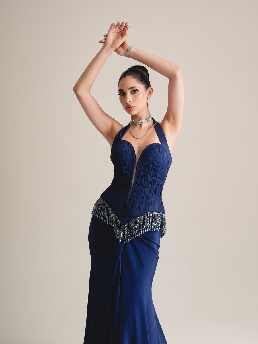 Three-quarter view of the navy halter plunge corset with V beaded fringe, arms raised overhead