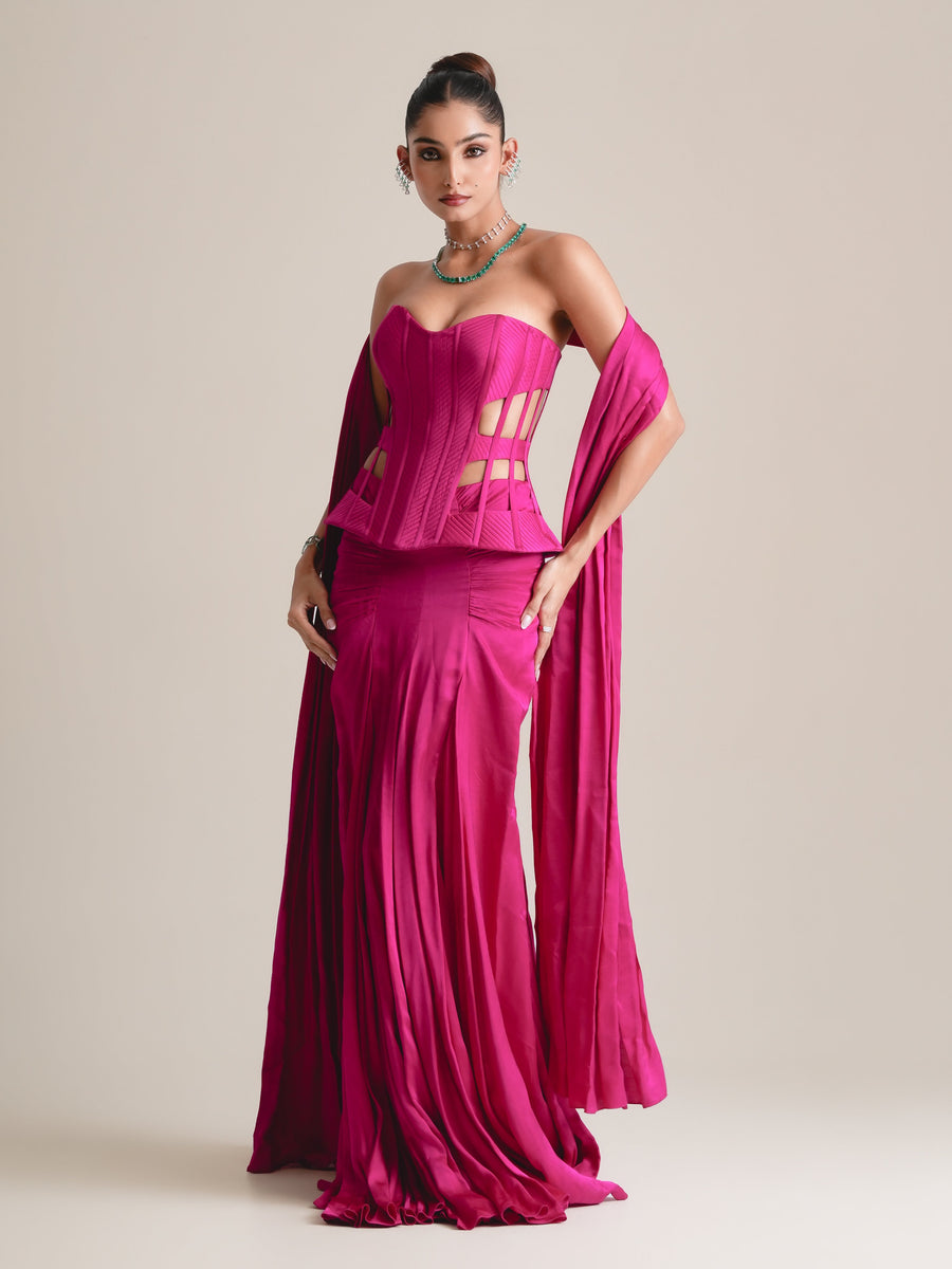 Hot-pink strapless cut-out cage corset with a long stole over the arms and a pleated drape skirt, full-length front view