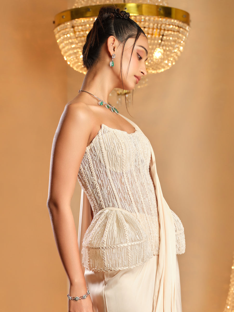 Side view of the white crystal-embroidered strapless corset with peplum and drape saree