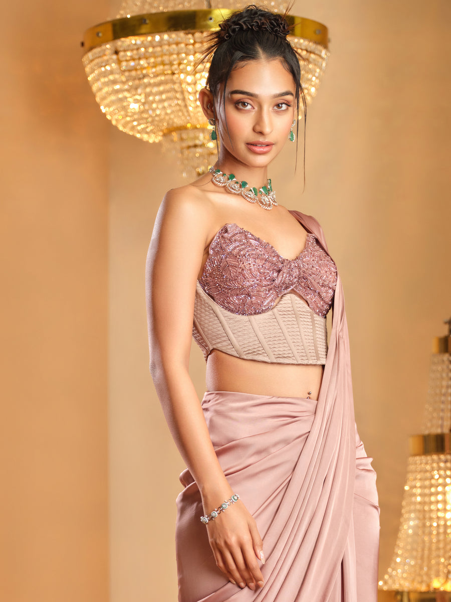 Close-up of the dusty pink double corset with embroidered bust and drape saree