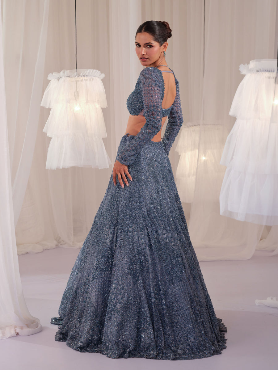 Back view of the metallic blue open-back blouse with lehenga