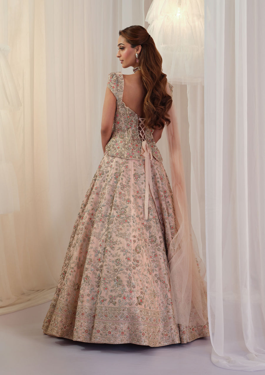 Back view of the blush pink lace-up corset with floral embroidered lehenga