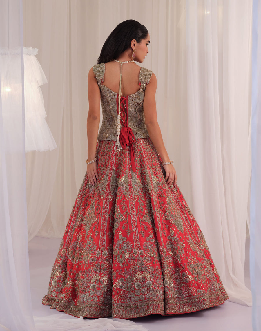 Back view of the hand-embellished corset with tie-back and red raw silk lehenga