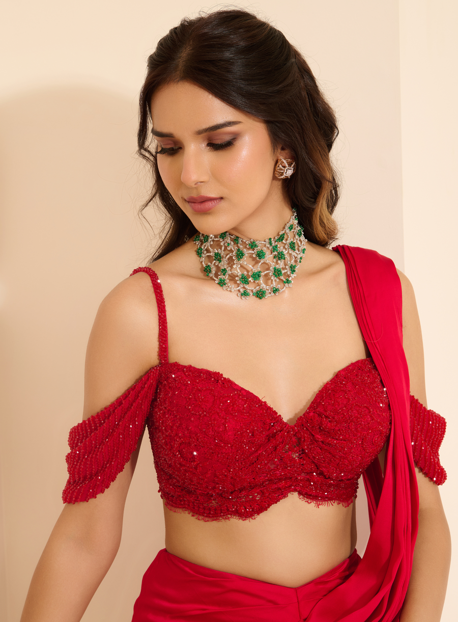 Close-up of the red crystal-embroidered lace bustier with off-shoulder straps