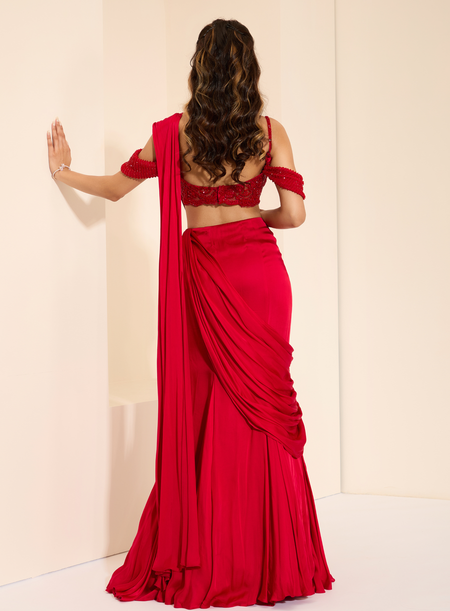 Back view of the red off-shoulder lace bustier with drape saree