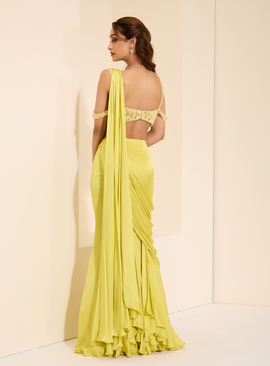Back view of the lime yellow off-shoulder lace bustier with drape saree