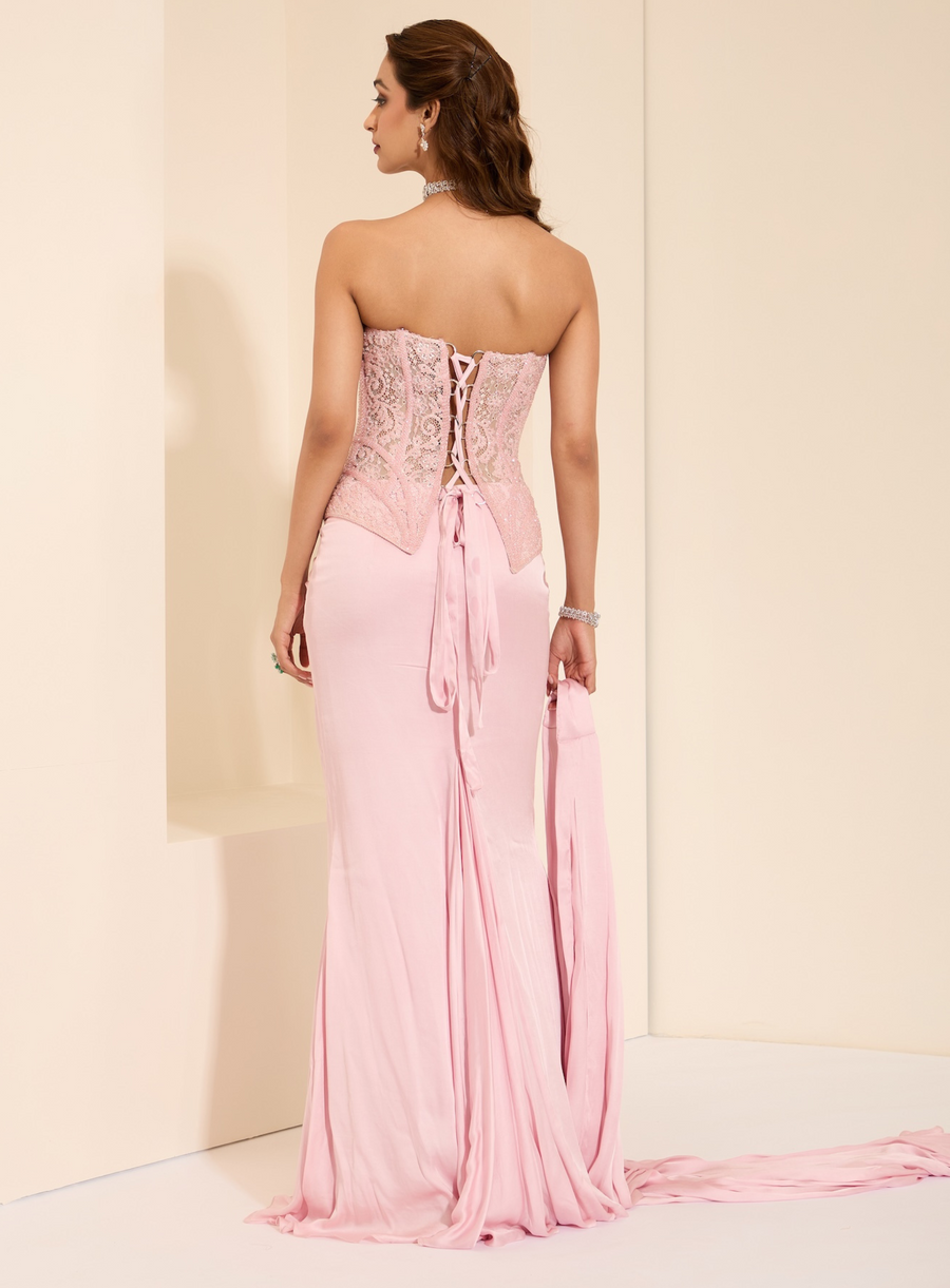 Back view of the baby pink lace-up corset with trailing drape skirt