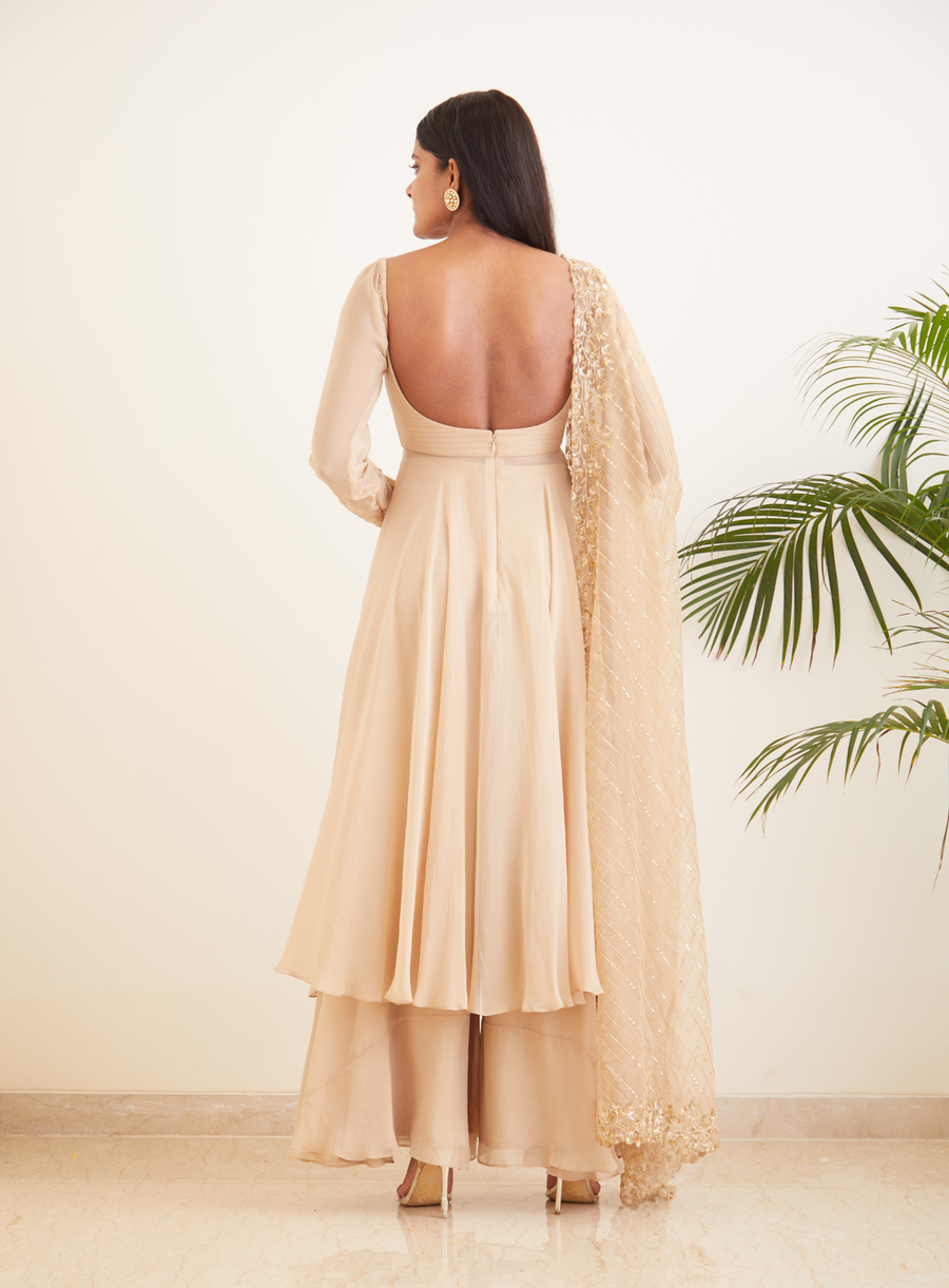 Back view of the beige open-back Anarkali set with embroidered dupatta