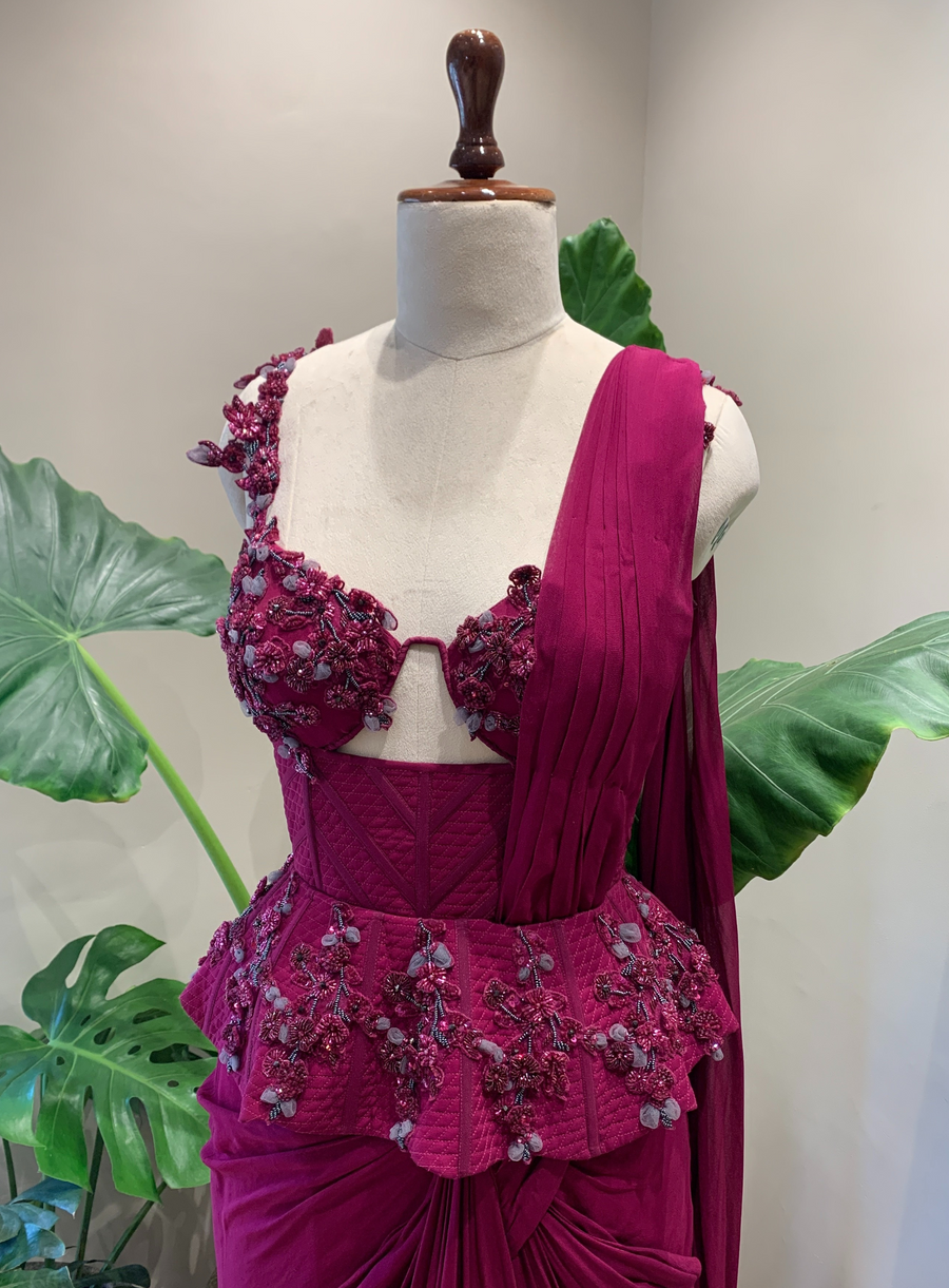 Close-up of the magenta quilted corset with 3D floral cutwork, peplum and pre-stitched drape