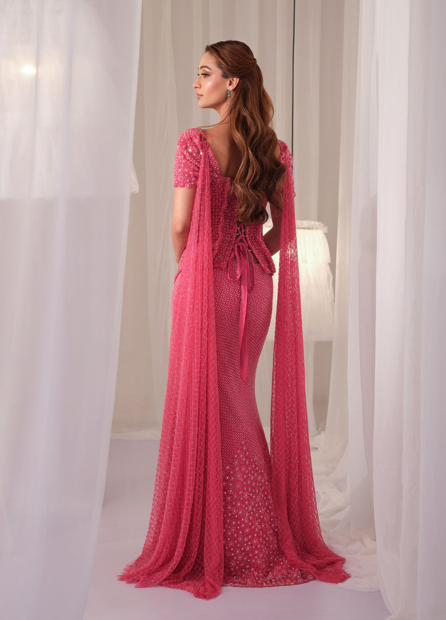 Back view of the barbie pink lace-up corset with fishcut lehenga and sheer drape
