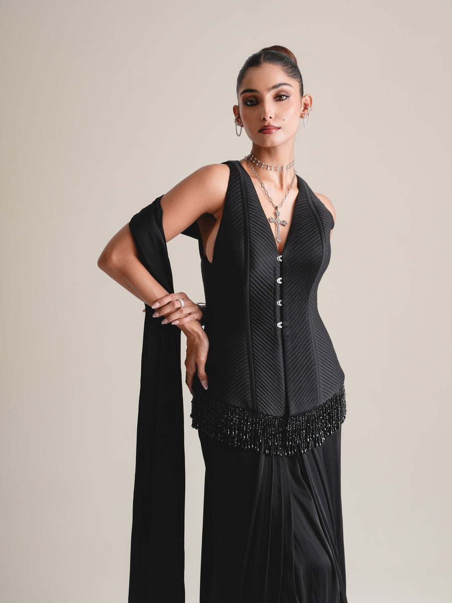 Close view of the black V-neck buttoned corset with quilted panels and hip-length beaded fringe, stole on the shoulder