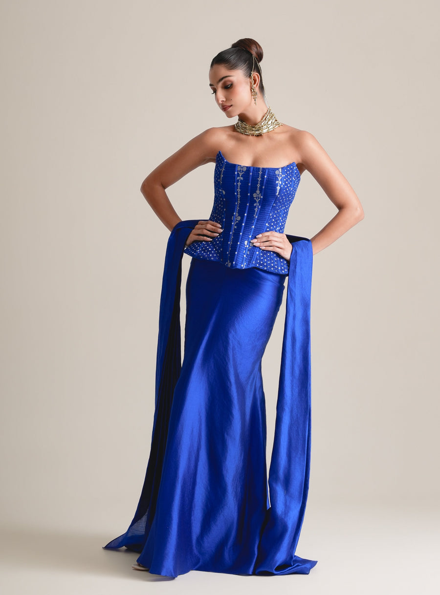 Electric blue embroidered peplum corset with stole and fishcut satin skirt, full-length front view, hands on hips