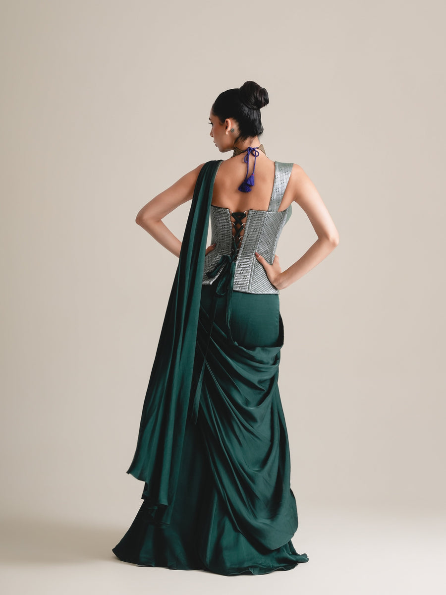 Back view of the silver-grey brocade corset with adjustable lacing and the bottle-green drape saree, full length
