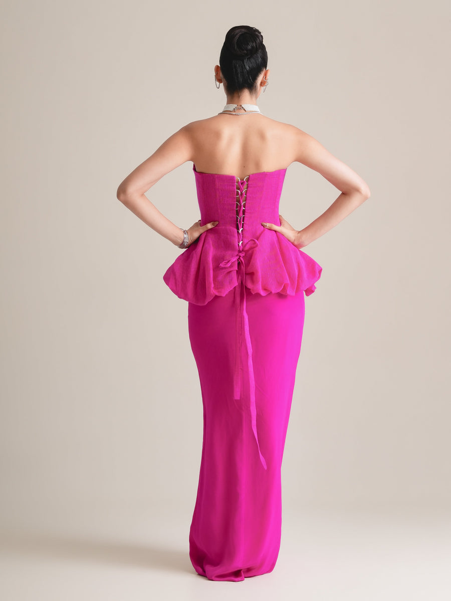 Back view of the fuchsia corset with lace-up back and bow, and the long pencil skirt, full length