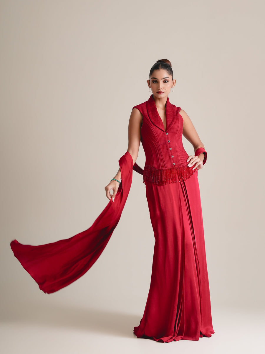 Red shawl-collar corset with beaded fringe and drape skirt, stole swept out to one side, full-length front view