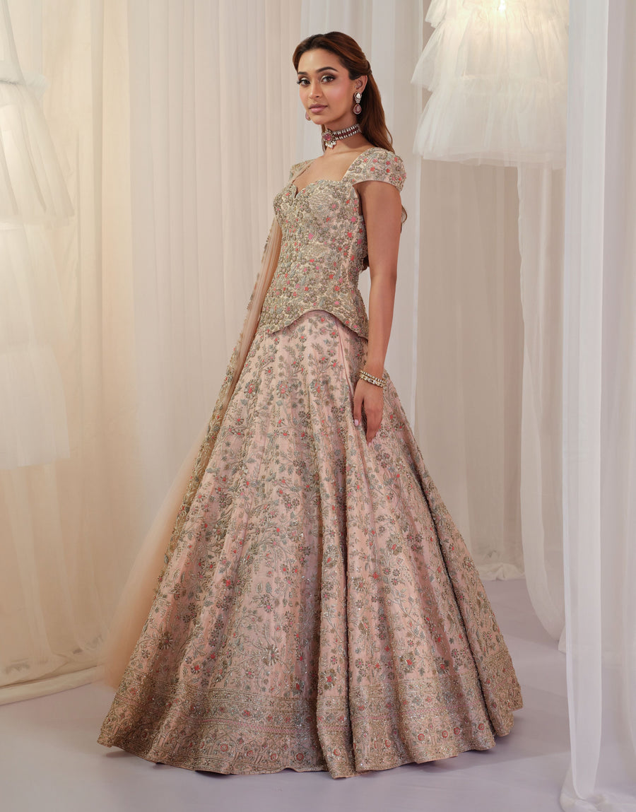 Full-length side view of the blush pink corset with floral embroidered lehenga
