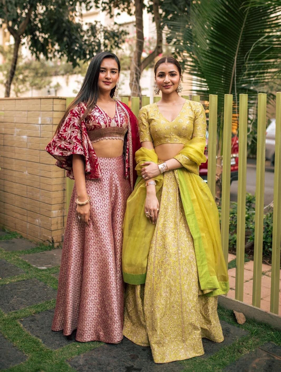Karishma and Ashita, founders of K&A, together in hand-embellished couture lehengas